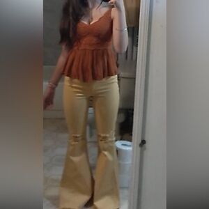 Yellow mid-rise flare jeans with ripped knees